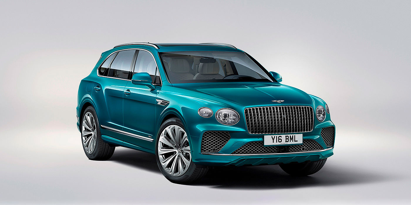 Bentley Zurich Bentley Bentayga Azure front three-quarter view, featuring a fluted chrome grille with a matrix lower grille and chrome accents in Topaz blue paint.