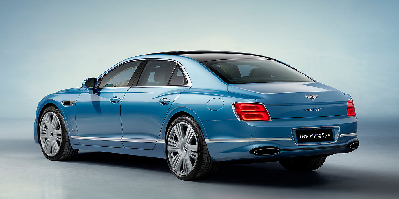 Bentley Zurich New Bentley Flying Spur Azure sedan rear view in Light windsor blue by Mulliner paint with 22 inch Azure wheels and chrome exterior details