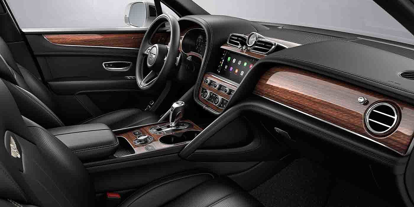 Bentley Zurich Bentley Bentayga EWB interior with a Crown Cut Walnut veneer, view from the passenger seat over looking the driver's seat.