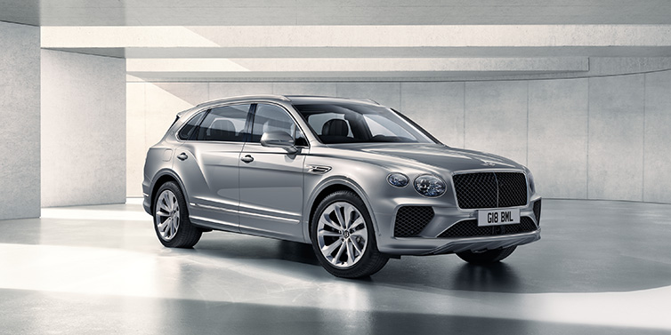 Bentley Zurich Bentley Bentayga Extended Wheelbase SUV front three quarter in Moonbeam paint with a grey background