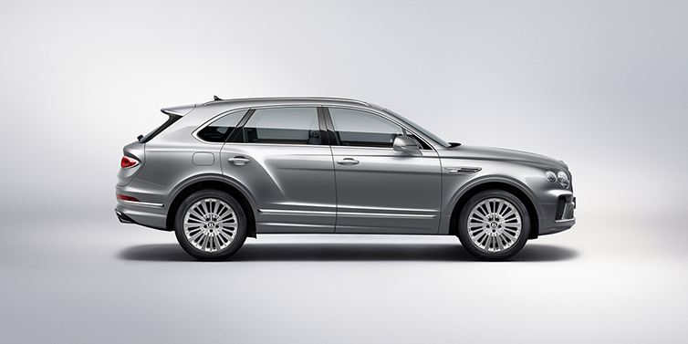 Bentley Zurich Bentley Bentayga SUV side profile in Moonbeam silver paint against white background featuring 21 inch 5 spoke wheels