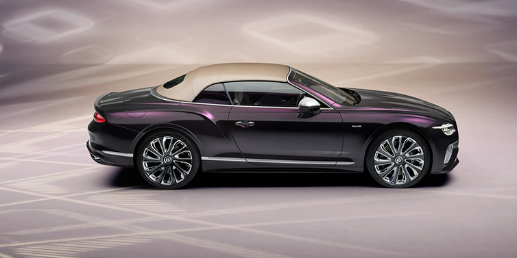 Bentley Zurich Bentley Continental GTC Mulliner convertible in profile with hood up, in Tanzanite Purple paint and 22 inch Mulliner painted and polished wheels