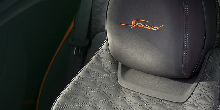 Bentley Zurich Bentley Continental GT Speed coupe seat detail in Gravity Grey hide and Speed emblem in Mandarin by Mulliner coloured embroidery