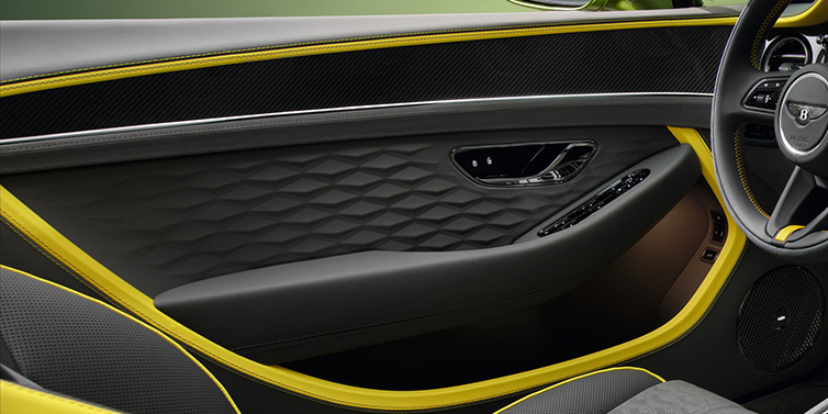 Bentley Zurich Bentley Continental GTC Speed convertible interior door details featuring Gravity Grey and Cyber Yellow by Mulliner hides and high gloss carbon fibre veneer