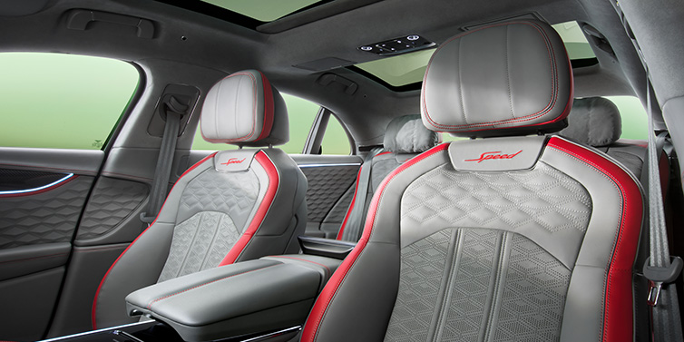 Bentley Zurich Bentley Flying Spur Speed sedan interior showing front and rear seats in Hotspur red and Gravity Grey hides, with Speed seat emblems