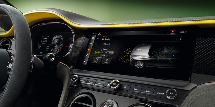 Bentley Zurich Bentley Continental GTC Speed convertible front interior centre console with MMI screen showing Air Quality visualisation surrounded by Cyber Yellow by Mulliner and Gravity Grey hides and high gloss carbon fibre veneer